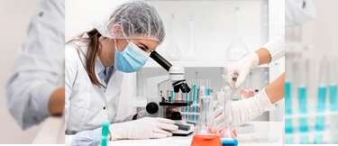 Technicians working in a lab using equipment supported by pathology lab software